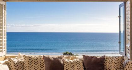 Premium 3BR beachside apartment, sea views, open living, 100 metres from beach