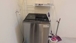 A compact kitchen with a stainless steel refrigerator, a washing machine, and a mop. - Full 2B2B Accessible Home on the 1st Floor, Sleeps 5, in Xinyi District, Taipei. (Taipei City)