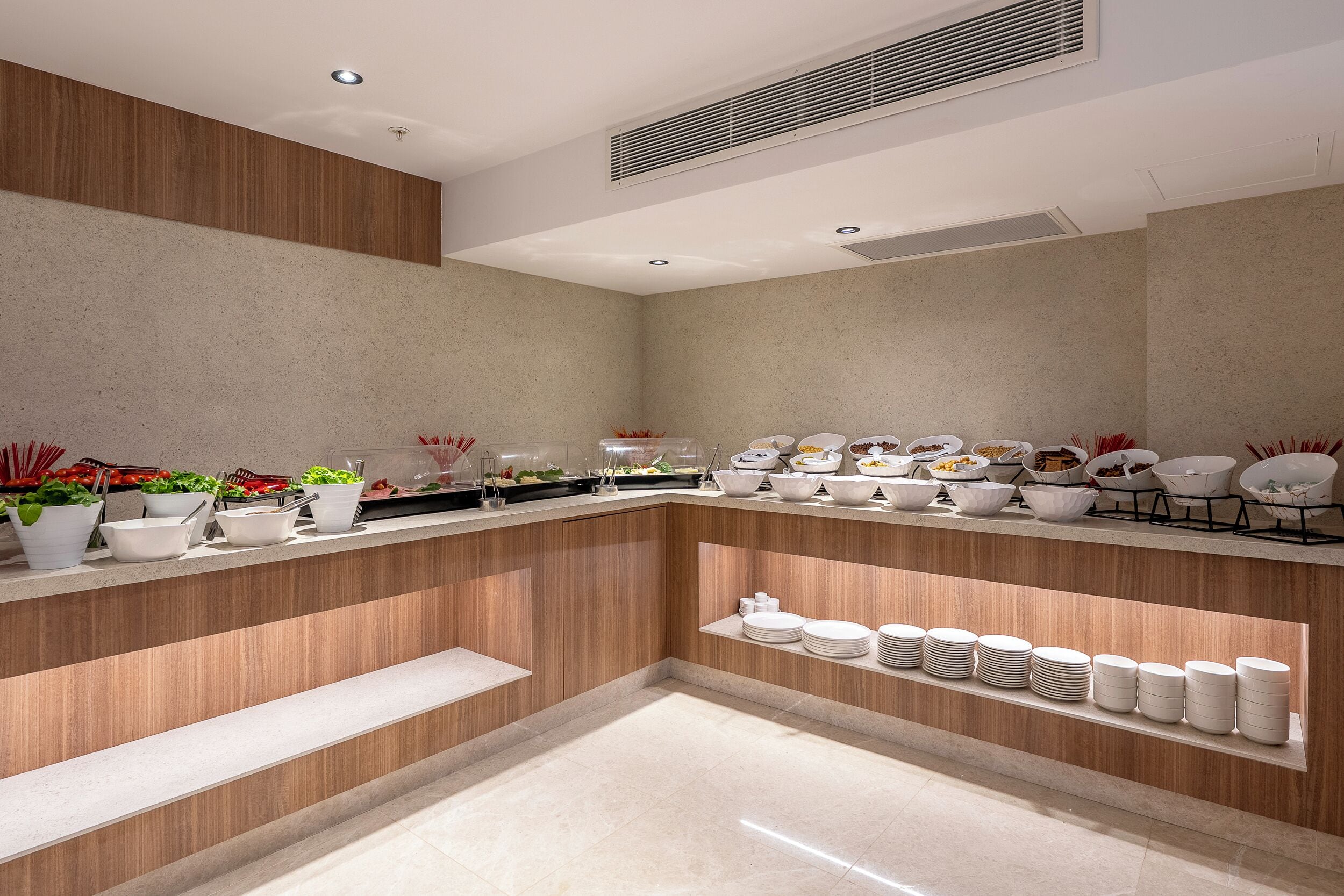 A modern kitchen with a built-in island, white appliances, and a variety of dishes and utensils.