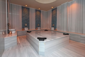 A modern bathroom with a large marble vanity, a sink, and a mirror. - The Marni Hotel (Antalya)