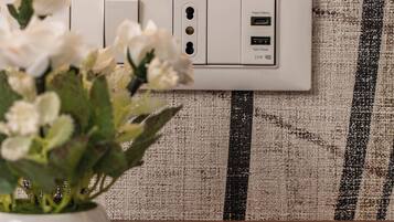 A power outlet with USB ports on a textured wall.