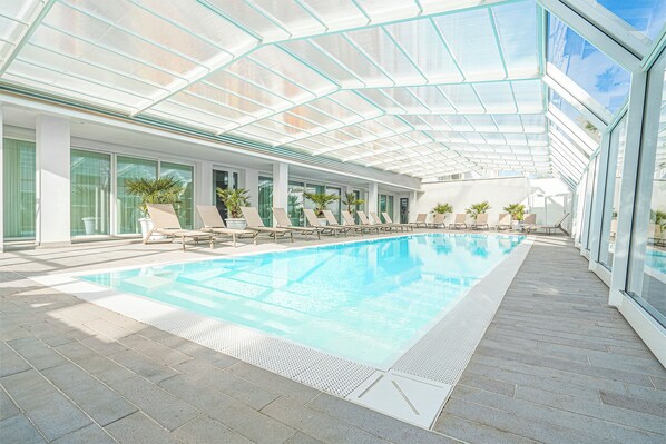 Indoor pool, seasonal outdoor pool, pool umbrellas, pool loungers