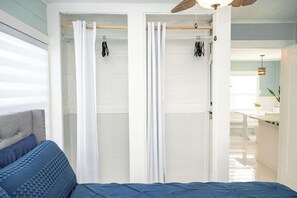 A bedroom with a bed, a wardrobe, and a ceiling fan. - Modern & Quiet Oasis, 1 minute walk to the Beach (Madeira Beach)