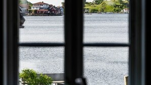 A view through a window of a body of water with buildings in the background.