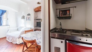 A compact kitchen with a gas stove, sink, and a small window. - GuestHost - A practical 20 square meters studio apartment, perfect for two people, located on the ground floor of a building with a private entrance.The property is located in the Nervi neighborhood, just 400 meters from Caprafico beach, making it easy f (Genoa)