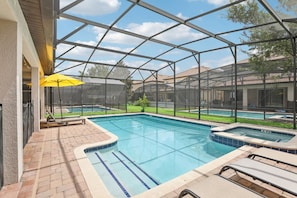 A pool area with a glass enclosure, lounge chairs, and a hot tub. - Upstay Family Home w Pool Cinema Championsgate (Davenport)