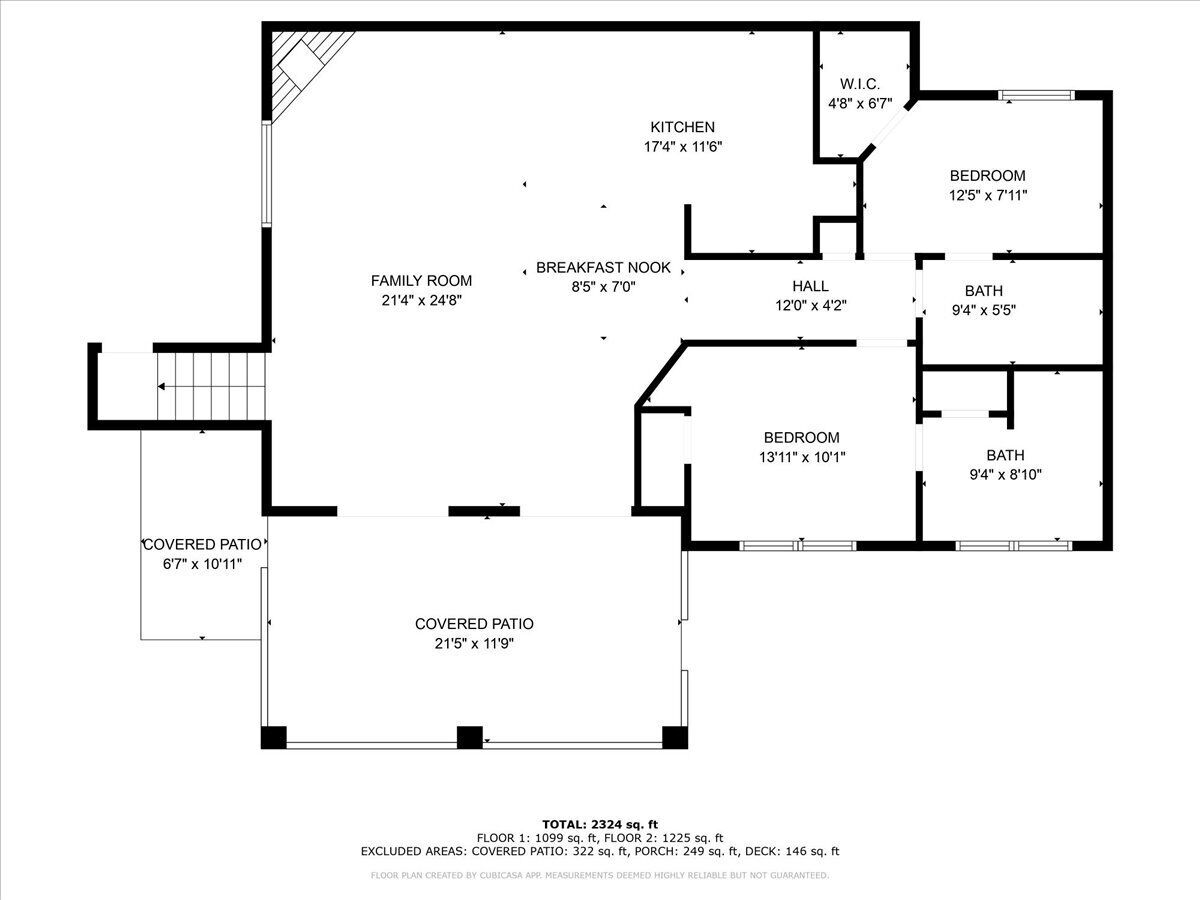 Grundriss eines Hauses mit überdachter Terrasse, Küche, zwei Schlafzimmern, Bad, einer Essecke und einem Familienzimmer.