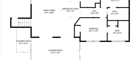 Grundriss eines Hauses mit überdachter Terrasse, Küche, zwei Schlafzimmern, Bad, einer Essecke und einem Familienzimmer.