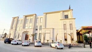 A large building with a symmetrical facade, multiple windows, and a central entrance. - Majestic Castle (Ludhiana)