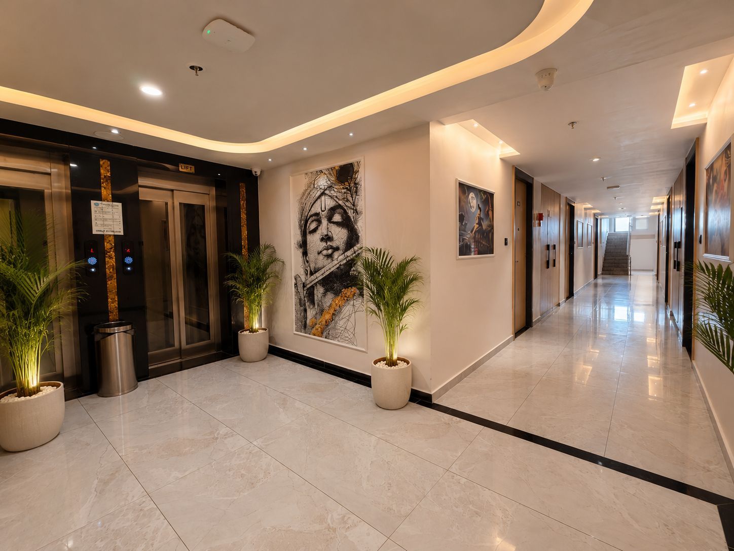 A hotel corridor with a modern design, featuring a marble floor, potted plants, and artwork on the walls.
