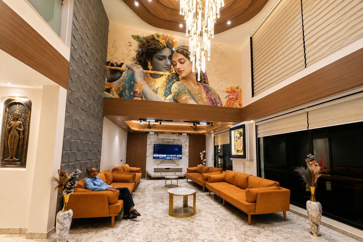 A lobby with a large mural, sofas, a TV screen, and a statue.