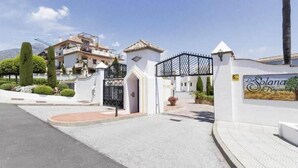Un cancello di accesso a un'area residenziale con un cartello che riporta 'La Solana de Nogales'.