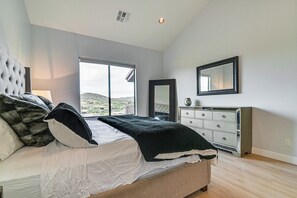 A bedroom with a bed, a dresser, a mirror, and a window with a view. - Pool Access: Mtn-view Getaway in Fountain Hills! (Fountain Hills)