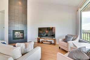 A modern living room with a fireplace, a flat-screen TV, and comfortable seating. - Pool Access: Mtn-view Getaway in Fountain Hills! (Fountain Hills)