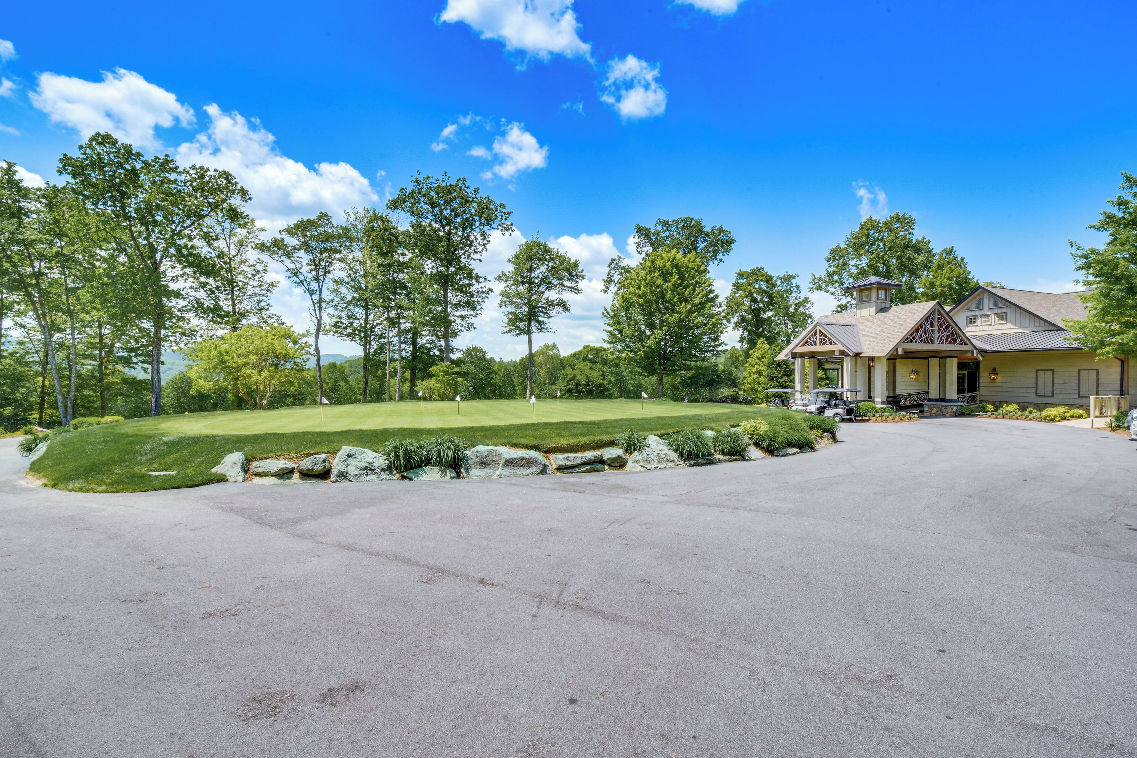 A large, single-story house with a spacious driveway and a well-maintained lawn.