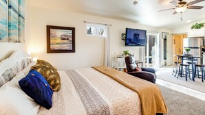 A bedroom with a bed, a window, a ceiling fan, and a view of the kitchen. - 4 Mi to Dtwn! Grand Junction Stay w/ Private Pool (Grand Junction)