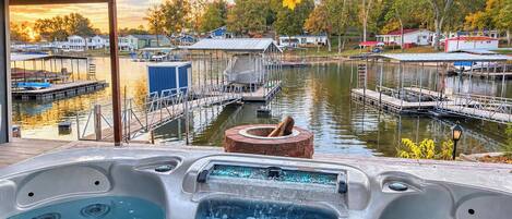 A hot tub with a view of a marina and docked boats.