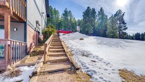 A wooden staircase leading up a snowy slope with a red car parked at the top. - Walk to Angel Fire Resort: Pet-friendly Getaway (Angel Fire)