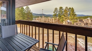 A balcony with a view of a residential area, including houses and trees. - Walk to Angel Fire Resort: Pet-friendly Getaway (Angel Fire)