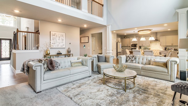 A spacious living area with a high ceiling, a staircase, and a kitchen in the background. - 9 Mi to Mystic Falls Tours! Spacious Group Getaway (Covington)