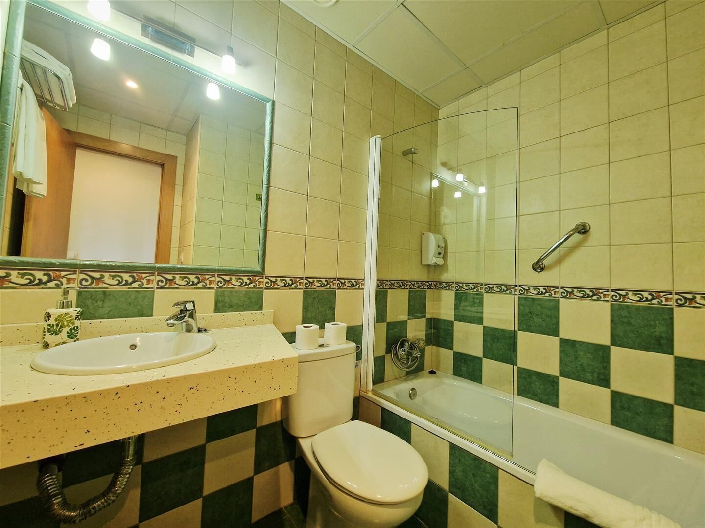 A bathroom with a sink, toilet, and bathtub.