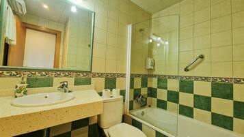 A bathroom with a sink, toilet, and bathtub.