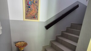 A staircase with a handrail, a tiled floor, and a decorative vase. - Beautiful home in gated community on private beach and Golf course in Costa Rica (Tambor)