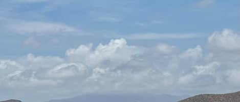 A mountainous landscape with a clear sky and a few clouds.
