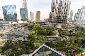 A modern urban landscape with high-rise buildings, a central roundabout, and surrounding greenery. - Elite 2BR Address Opera Burj Khalifa View (Dubai)