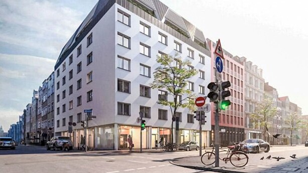 A modern building with multiple floors, large windows, and a prominent corner entrance. - Munich Finest Apartments 6 by Interhome (Munich)