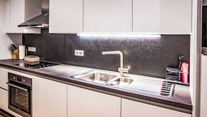 A modern kitchen with stainless steel appliances, a double sink, and a built-in oven. - Munich Finest Apartments 6 by Interhome (Munich)