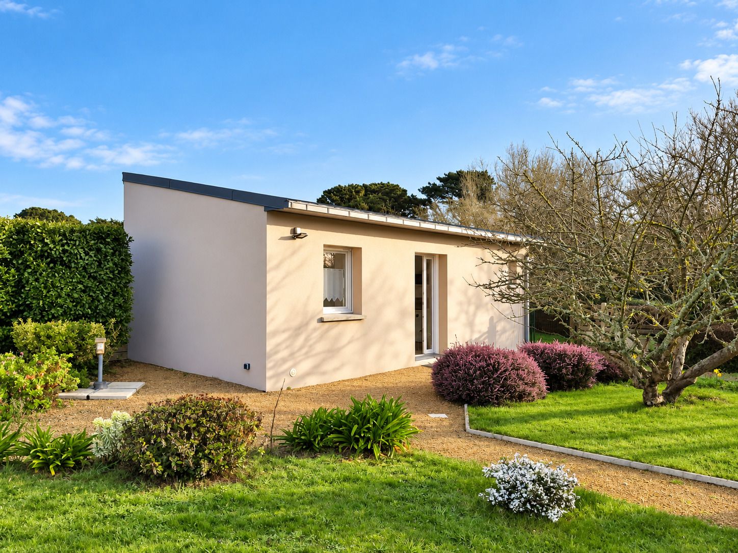A single-story building with a flat roof, a small window, and a door.