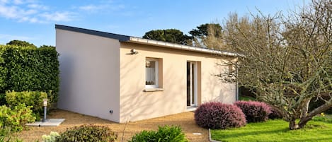 A single-story building with a flat roof, a small window, and a door.