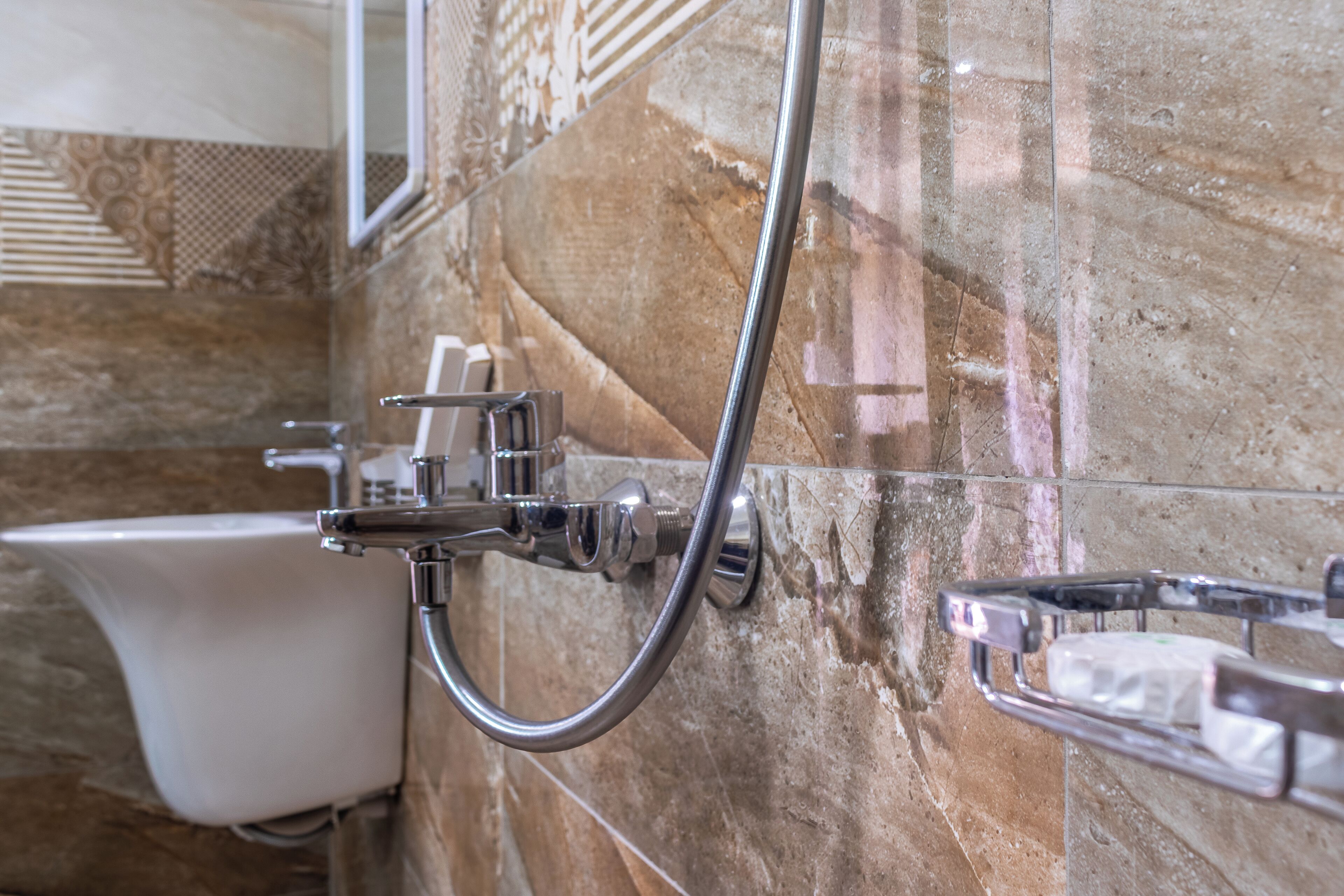A bathroom with a shower, a toilet, and a towel rack.