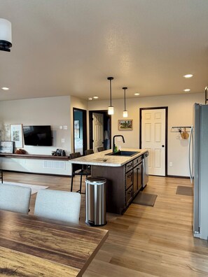 A modern kitchen with a central island, built-in appliances, and pendant lighting. - Ridge View Retreat! 2 bed, 2 bath with View and Garage (Rapid City)