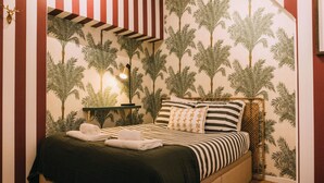 A bedroom with a bed, pillows, a nightstand, and a lamp. - Saudade Apartment (Lisbon)