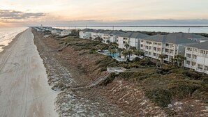 Ett hotell vid stranden med flera våningar, en sandstrand och fri utsikt över havet.