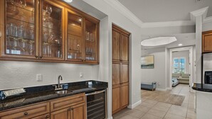 A kitchen with wooden cabinets, a stainless steel sink, and a built-in oven. - 3 bed- 2 bath Condo - community pool and hot tub (Cape Coral)
