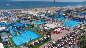A resort with multiple swimming pools, water slides, and beach areas. - Hotel Mimosa (Riccione)