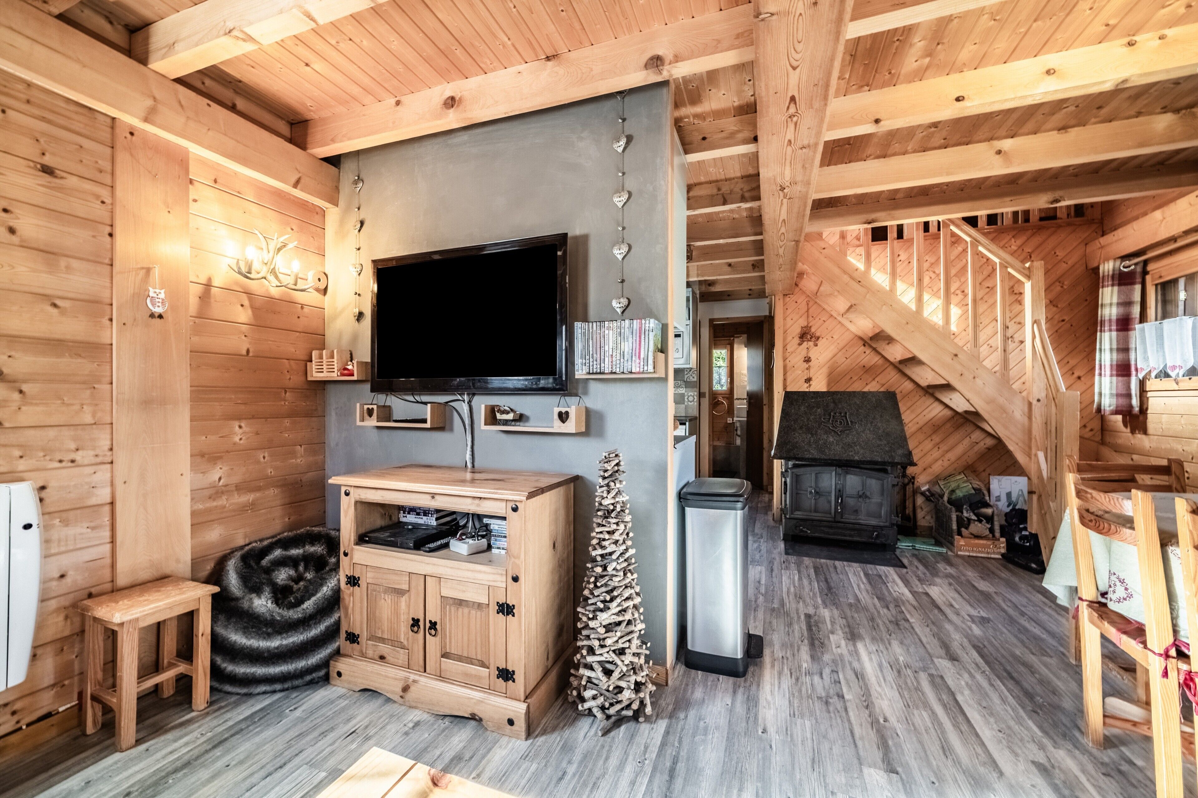 A wooden interior with a television, fireplace, and wooden cabinets.