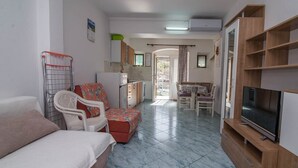 A compact living space with a kitchenette, a dining area, a TV, and a small seating area. - Zdenka / Rovenska in Veli Lošinj (Veli Lošinj)