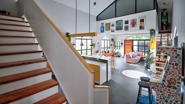 A modern interior with a staircase, open-plan living area, kitchen, and dining space. - Converted Chapel Villa · Private Pool + Arcade (Dumaguete City)