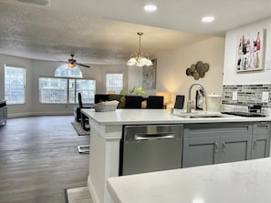 A spacious kitchen with a large island, modern appliances, and a dining area with a view.
