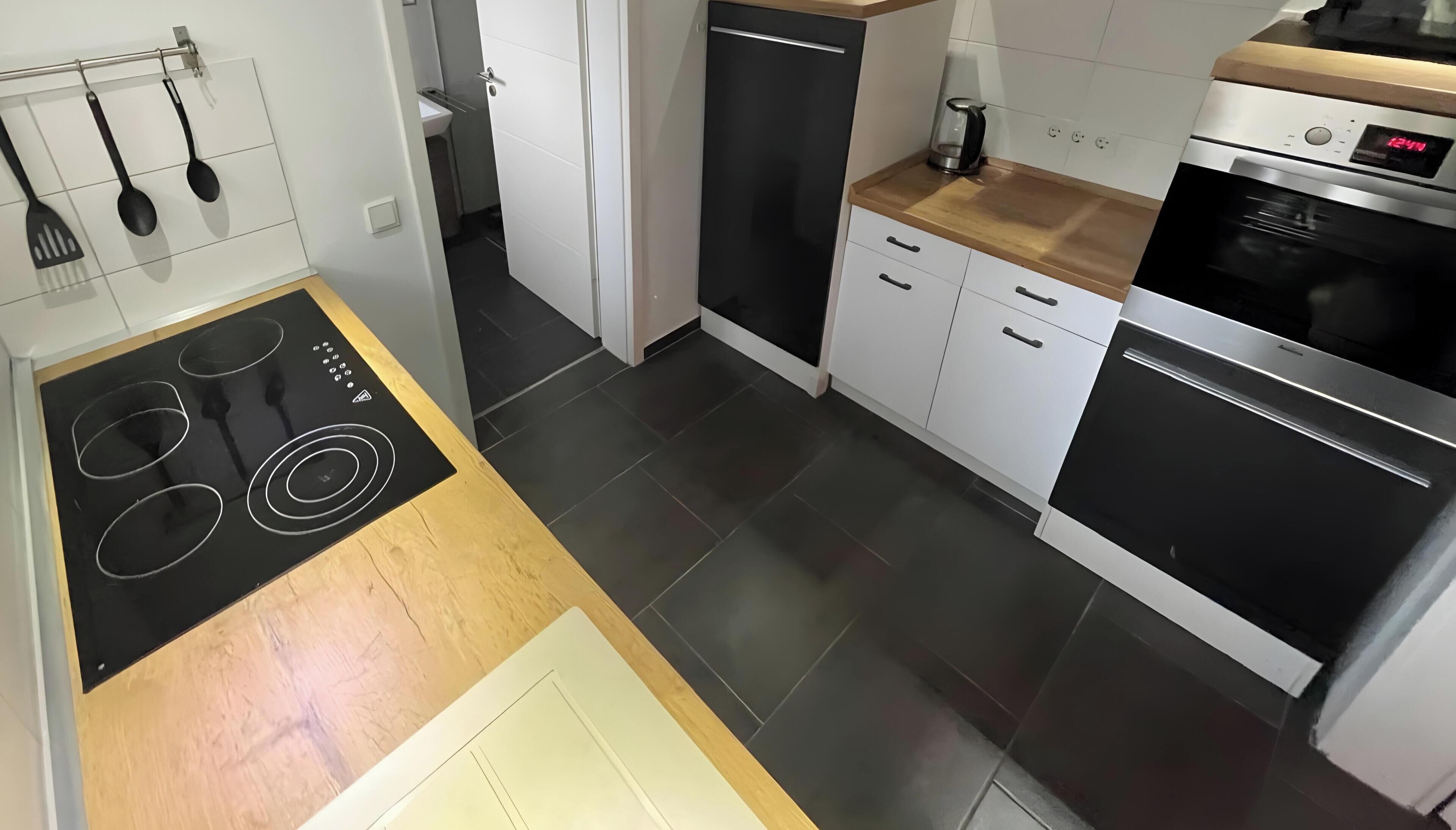 Eine moderne Küche mit Einbauherd, Backofen und Geschirrspüler.