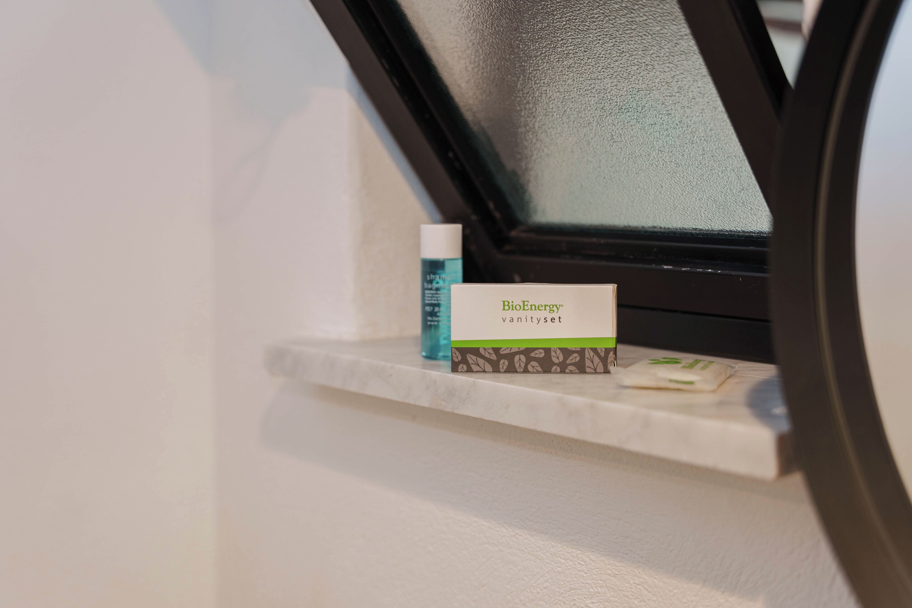 A shelf with a BioEnergy vanity set and a bottle.