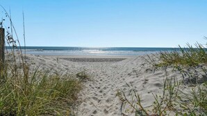 A sandy beach with sparse vegetation and a clear sky. - Ocean Edge 204- Cherry Grove 2BR- Pool (North Myrtle Beach)