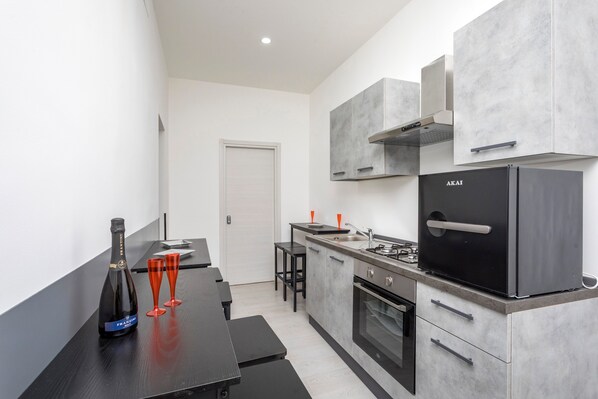 A modern kitchen with a built-in stove, oven, and a refrigerator.