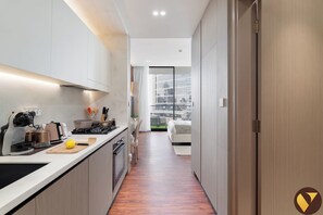 Luxury Studio, Balcony, City View | Private kitchen | Full-size fridge, microwave, oven, stovetop - Vogue | Binghatti Phoenix JVC Near Circle Mall (Dubai)
