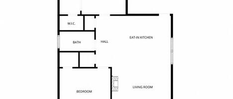 A floor plan with a primary bedroom, two bathrooms, a W.C., a hall, an eat-in kitchen, a living room, and a bedroom.