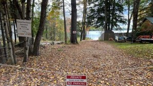 A private area with a sign indicating a meeting and a no parking sign. - Charming 1-Bedroom Cabin, full bath, outdoor sauna and boat ramp access to lake (Casco)